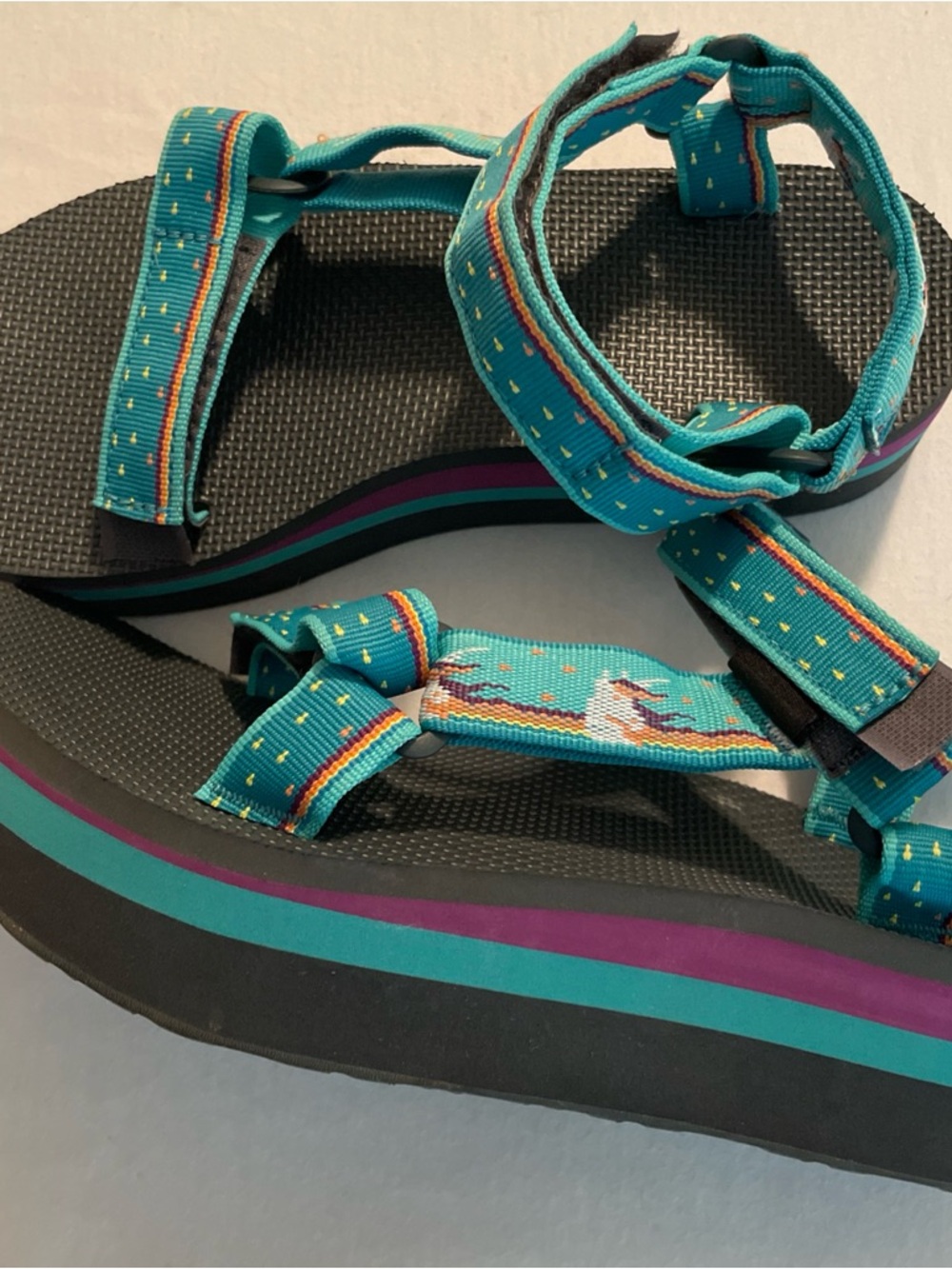 Teva turquoise sandals with yellow and purple accents